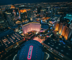 High angle view of city lit up at night