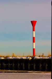 Red lighthouse against sky