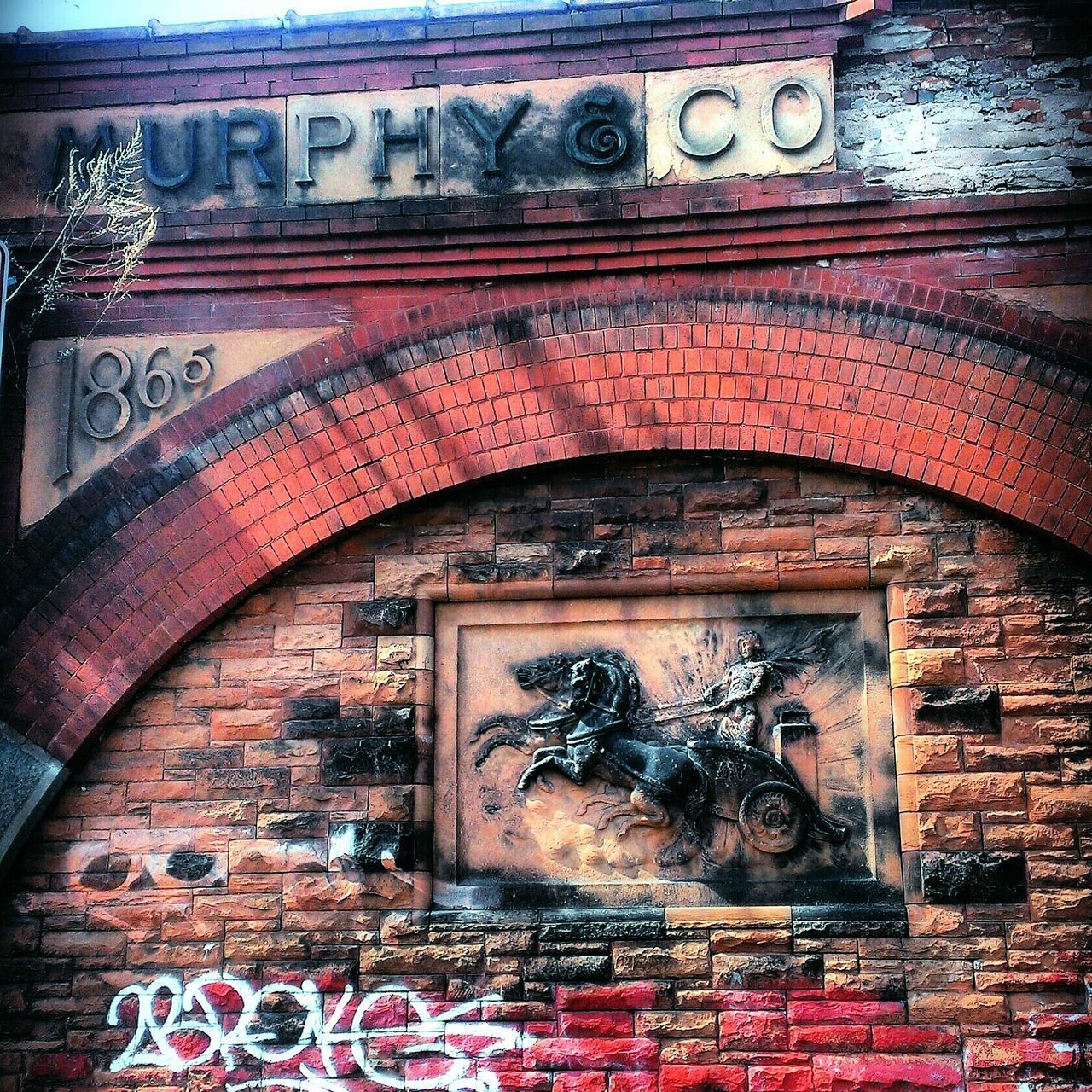 architecture, built structure, old, building exterior, arch, text, graffiti, weathered, wall - building feature, brick wall, door, abandoned, close-up, western script, art and craft, outdoors, obsolete, rusty, damaged, no people