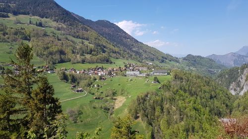 Scenic view of landscape and houses against sky