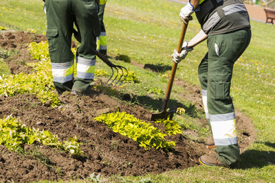 Low section of men gardening