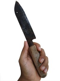 Close-up of hand holding ice cream over white background