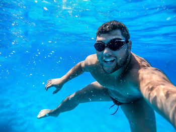 Portrait of man swimming in pool