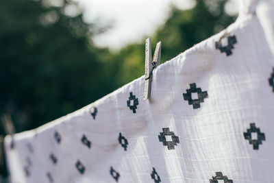 Low angle view of clothespins hanging on clothesline