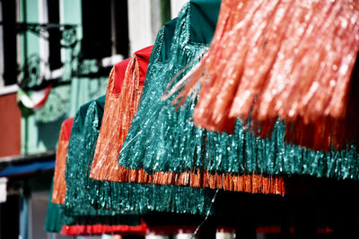 Close-up of tinsel hanging at market stall