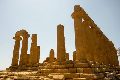 Low angle view of ruined pillared structure