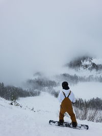 Man snowboarding on snowcapped mountain