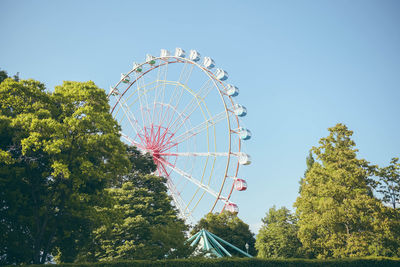 Low angle view of ferris wheel against sky