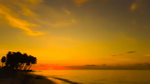 Scenic view of sea against romantic sky at sunset