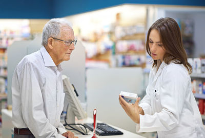 Pharmacist giving medicine to patient