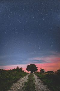 Dirt road against sky at night