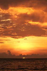 Scenic view of sea against romantic sky at sunset