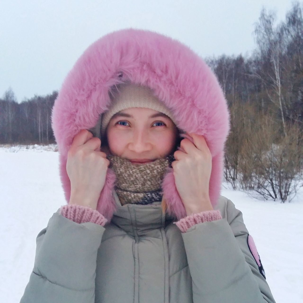 winter, snow, looking at camera, cold temperature, warm clothing, real people, one person, portrait, front view, pink color, leisure activity, smiling, day, lifestyles, outdoors, young women, childhood, young adult, happiness, nature, close-up