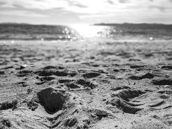 Surface level of sand on beach against sky