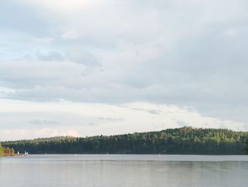 Scenic view of lake against cloudy sky