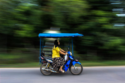 Man riding motorcycle on road