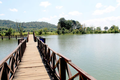 Scenic view of pier over lake against sky