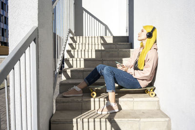 Side view of man sitting on staircase