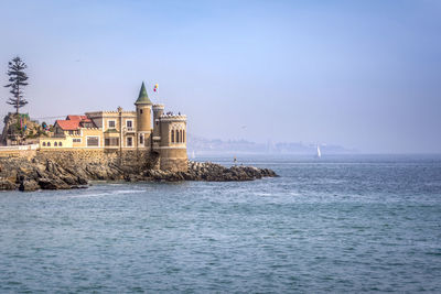 A castle by sea against clear sky