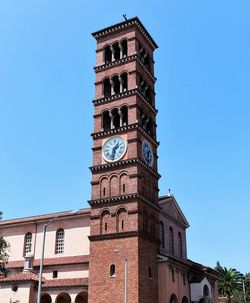 Low angle view of clock tower against clear sky