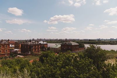 Plants and buildings against sky