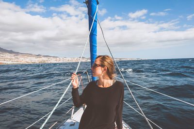 Young woman sitting in boat on sea