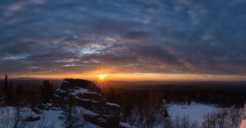 Scenic view of snowcapped mountains against sky during sunset