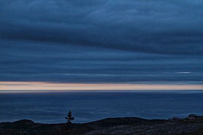 Scenic view of sea against cloudy sky