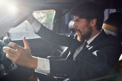 Angry businessman sitting car