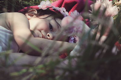 Close-up of young woman sleeping on flowers