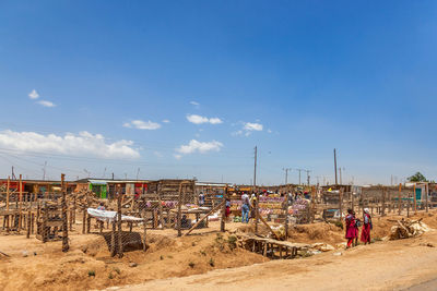 People working at construction site against sky