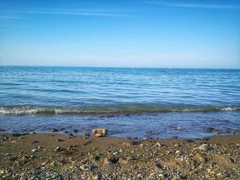 Scenic view of sea against blue sky