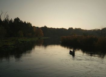 Scenic view of lake with trees in background