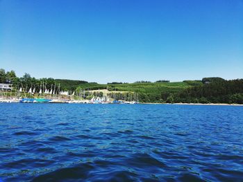 Scenic view of sea against clear blue sky