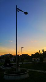 Street light against sky at sunset