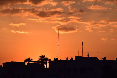 Low angle view of silhouette buildings against sky during sunset