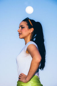 Portrait of young woman against white background