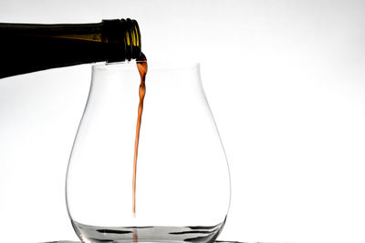 Close-up of beer bottle against white background