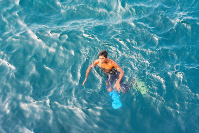 High angle view of man swimming in sea