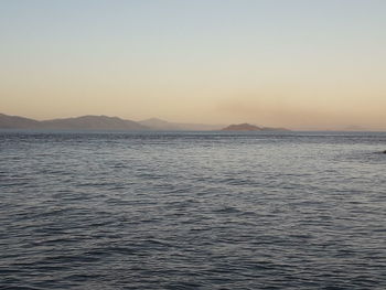 Scenic view of sea against clear sky during sunset