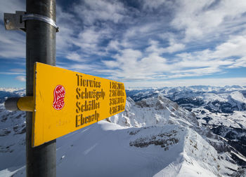 Information sign against sky