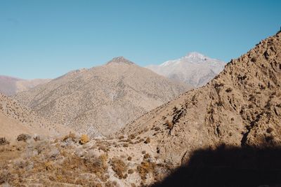 Scenic view of desert against clear blue sky