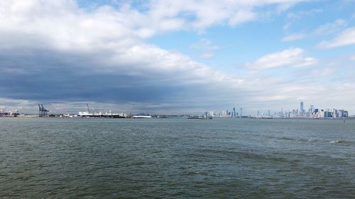 Scenic view of sea and buildings against sky