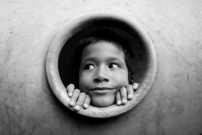 Close-up of boy looking through circle at playground