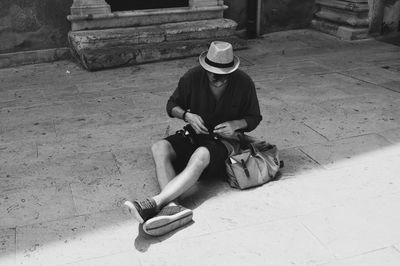 High angle view of man sitting on sofa