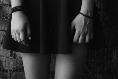 Midsection of woman standing indoors