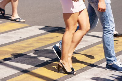 Low section of people walking on road