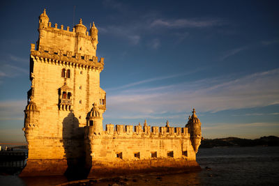 Historic building against sky at sunset