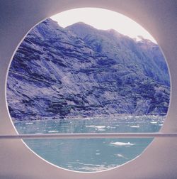 Scenic view of sea and mountains against sky