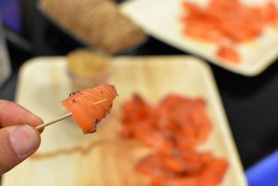 Close-up of a hand holding sushi